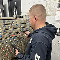 Technician scanning a parts drawer barcode for Customer Managed Inventory ordering